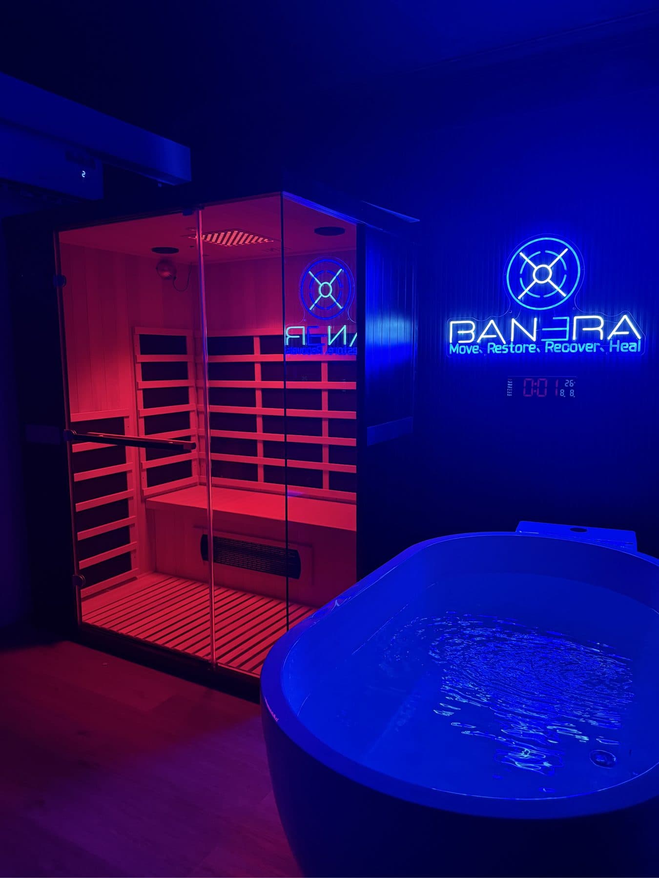 Banera’s recovery room: infrared sauna and ice bath under the neon logo